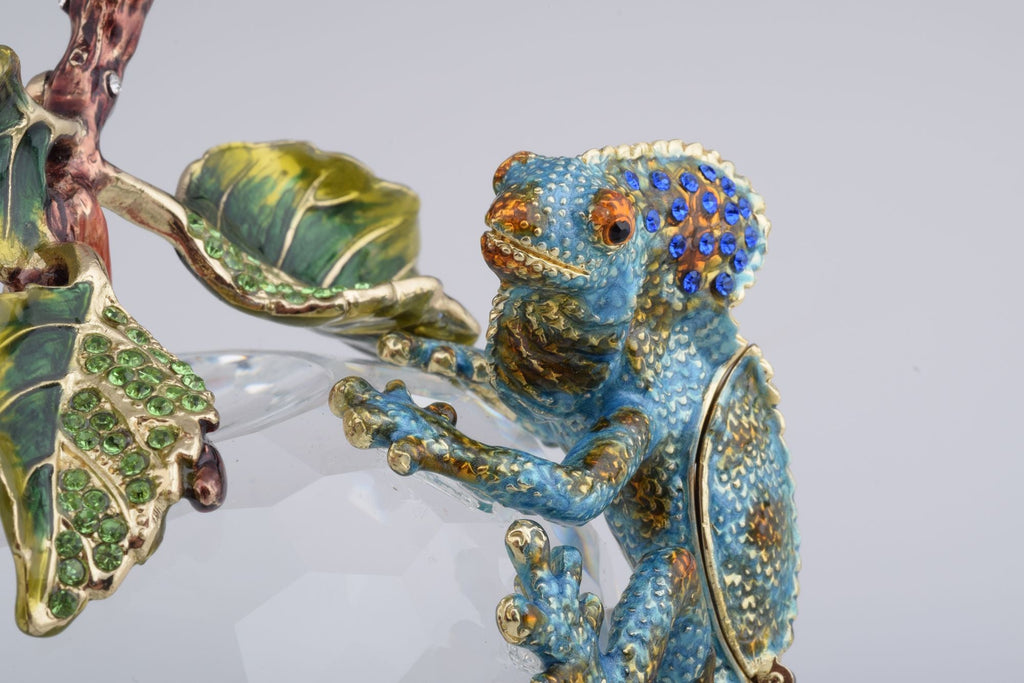 Decorative Chameleon figurine with gemstones on a gray background