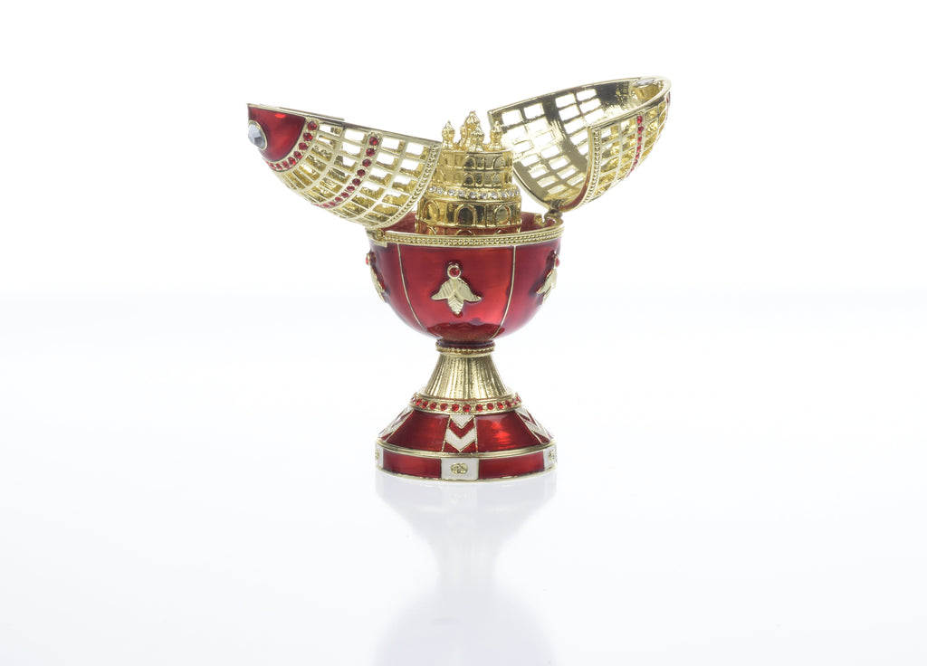 Decorative red and gold cup with intricate design on a white background