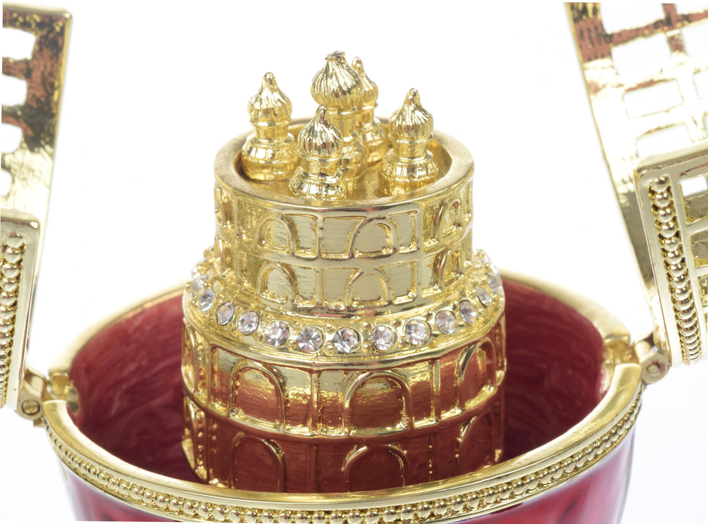 Decorative box with gold architectural design and red interior