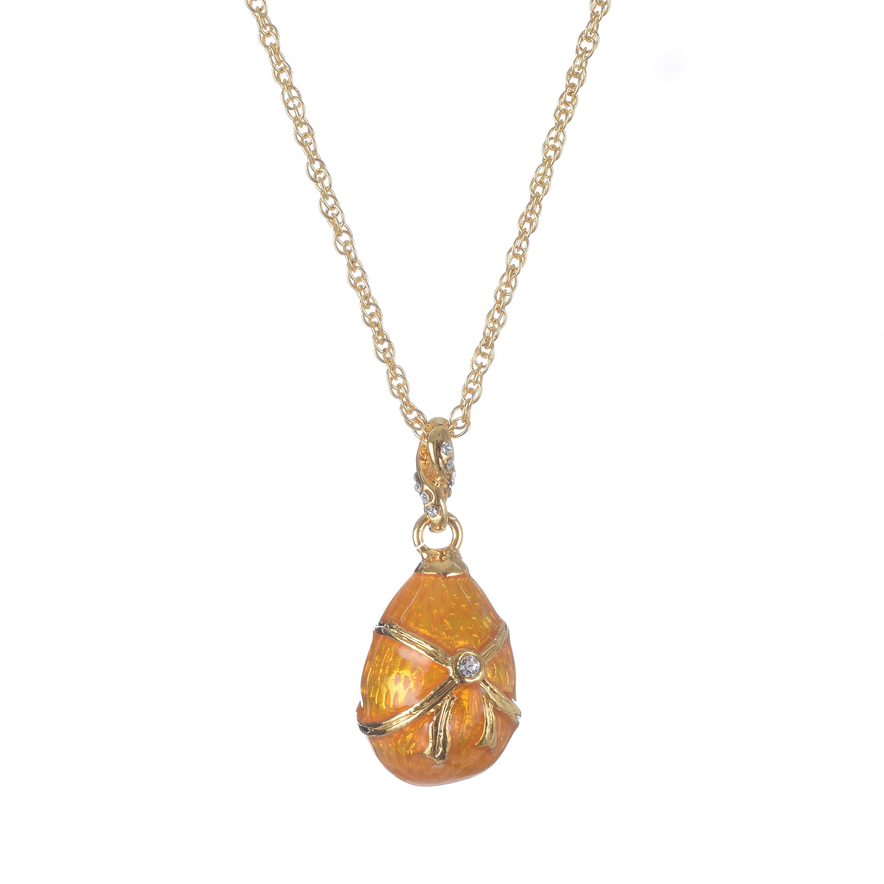 Gold necklace with an orange egg-shaped pendant on a white background