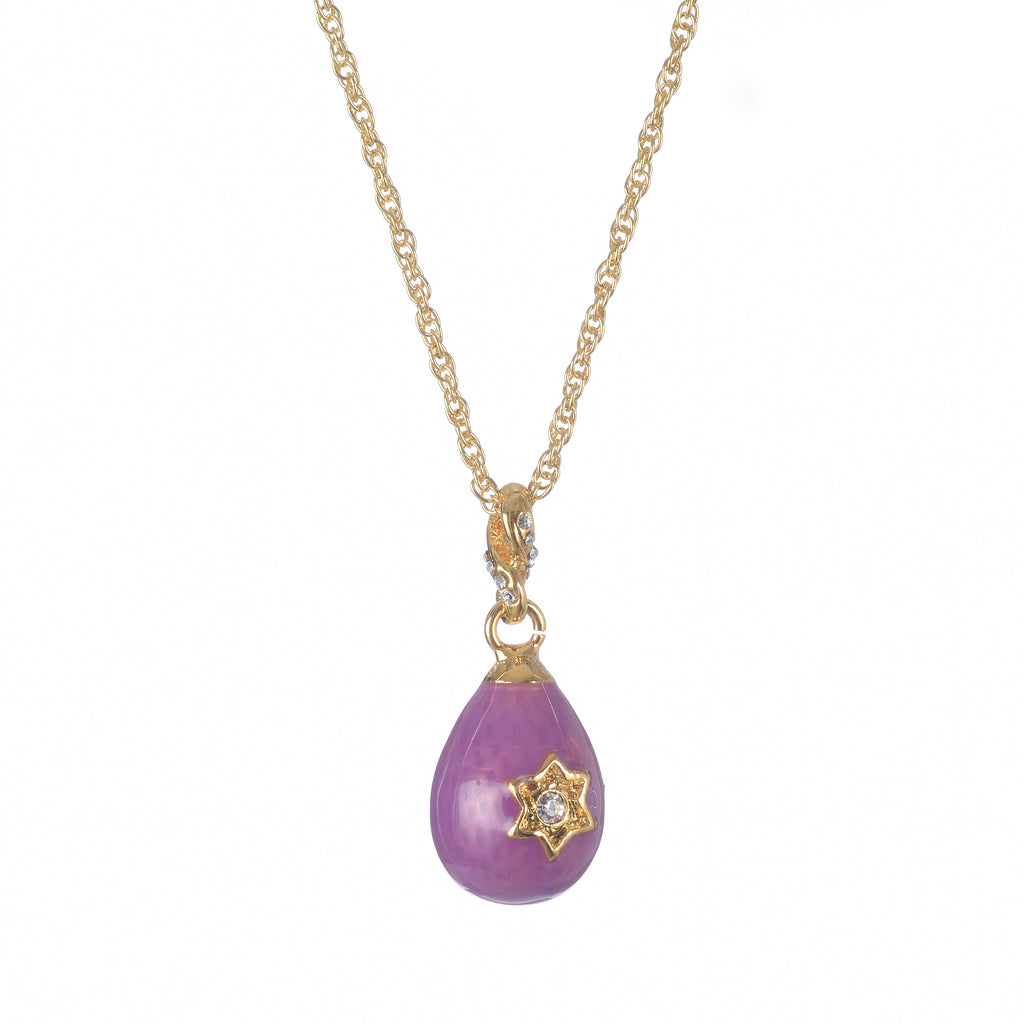 Purple teardrop pendant with gold star detail on a gold chain against a white background