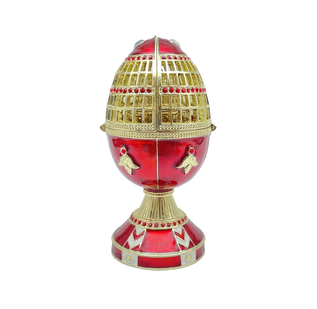 Decorative egg with gold and red design on a white background