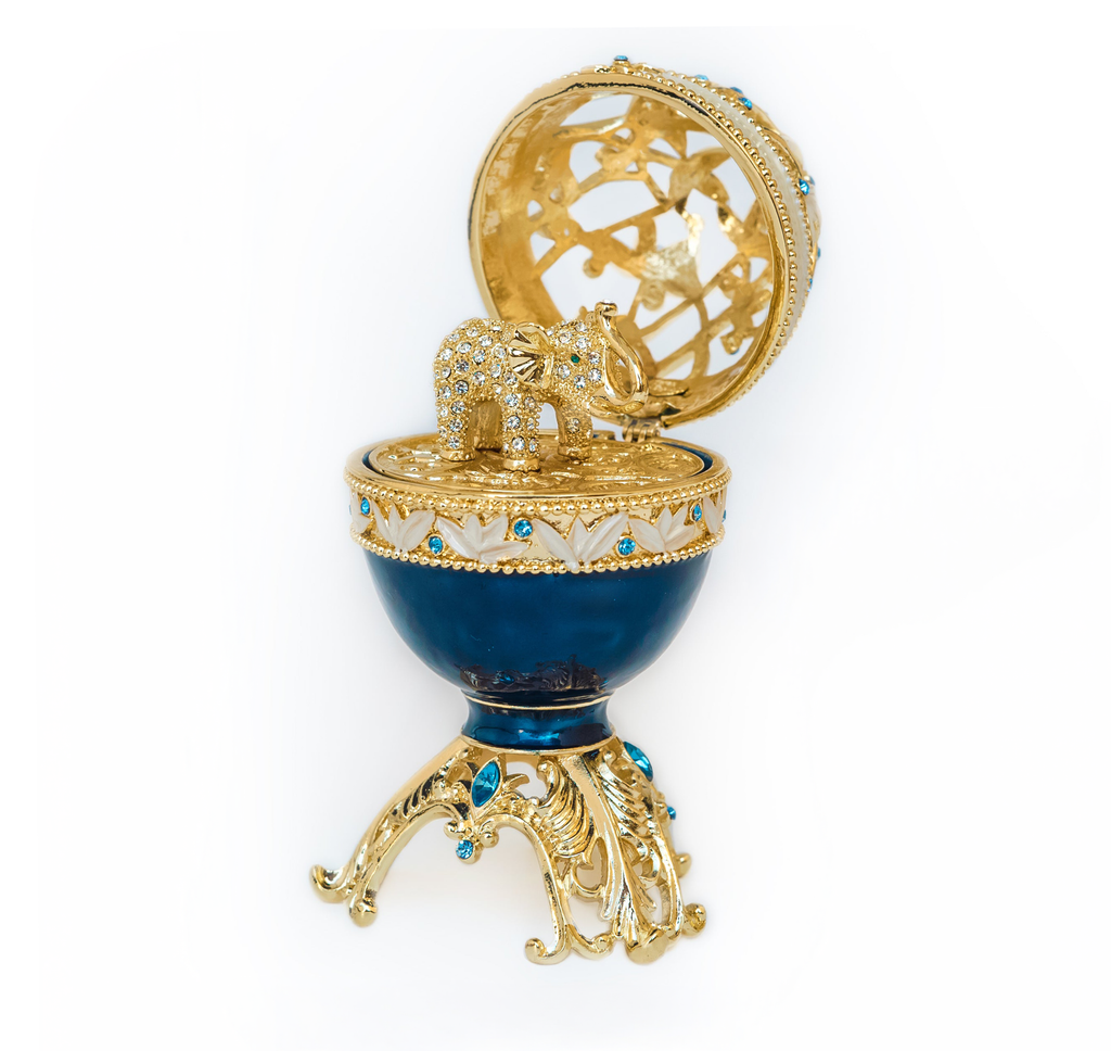Decorative egg with gold and blue design on a white background