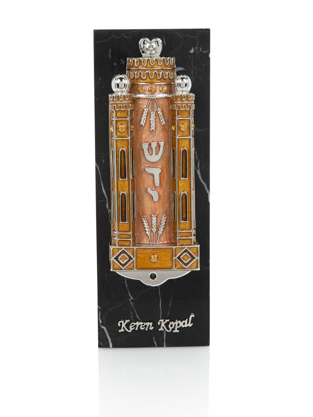 Decorative mezuzah case with intricate design on a black background