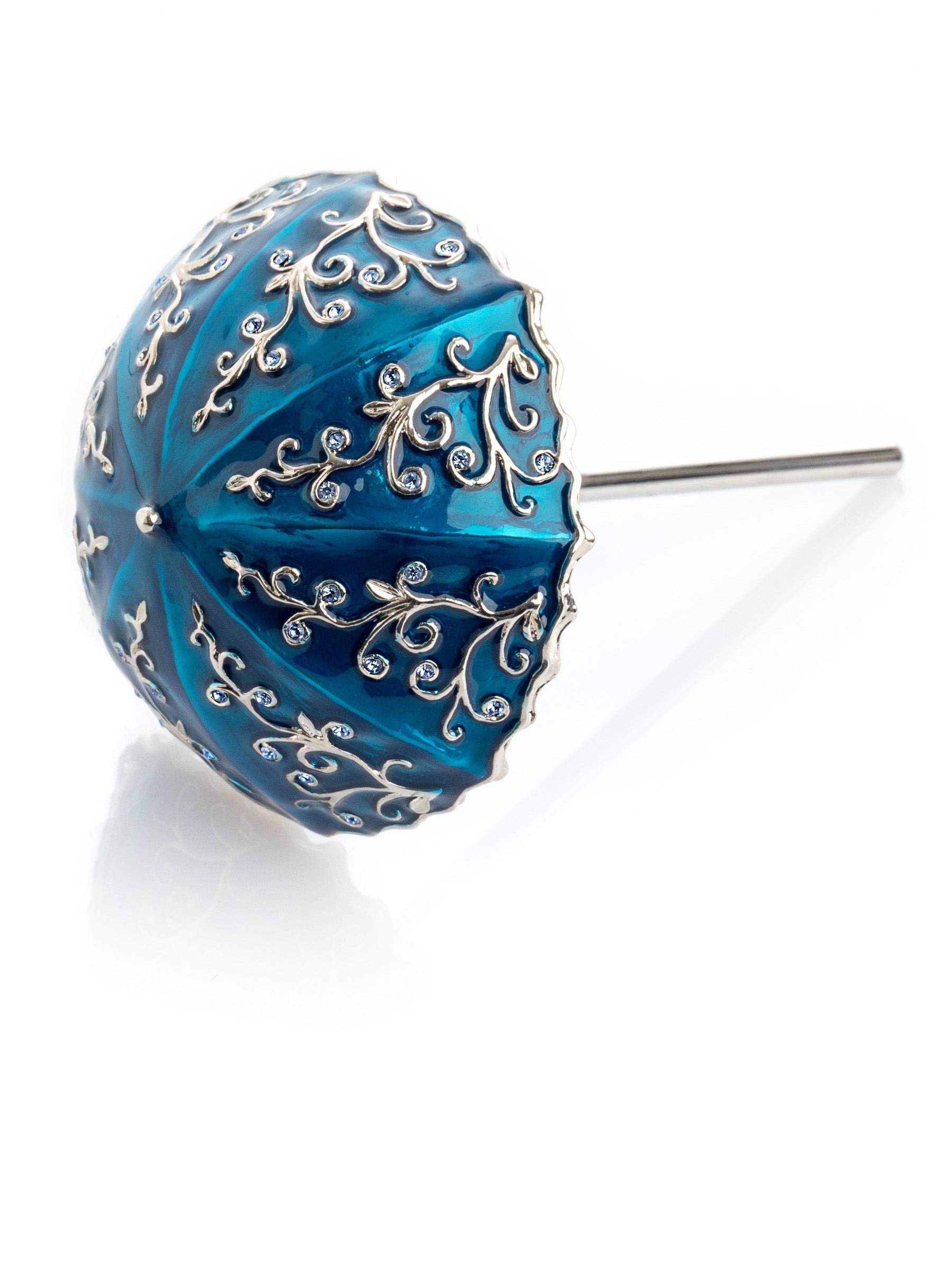 Blue decorative sphere with silver filigree on a white background
