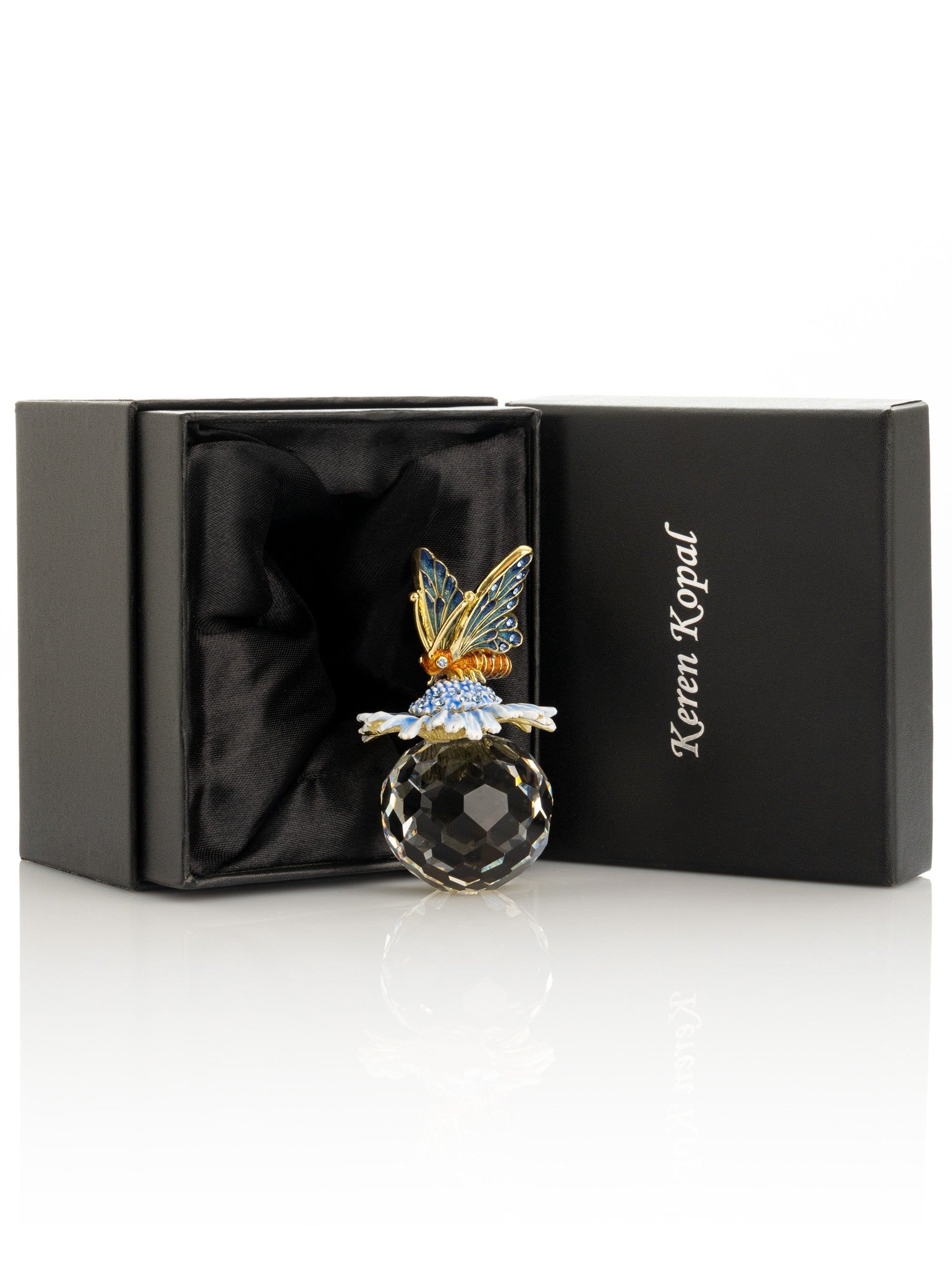 Blingy butterfly brooch on a black box with 'Keren Kopal' branding