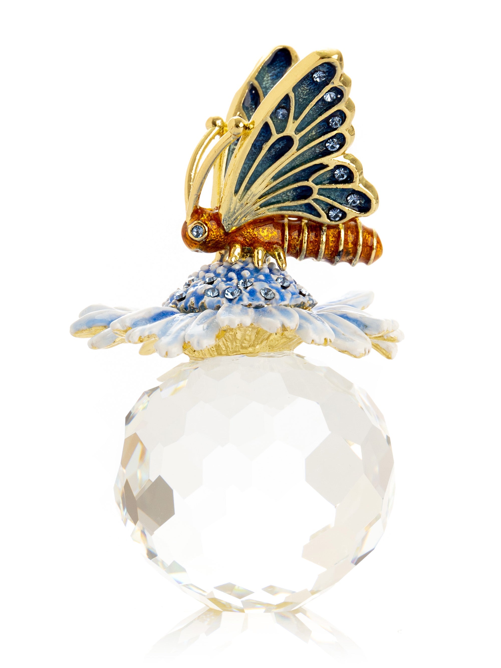 Decorative object with a butterfly on top of a crystal ball on a white background