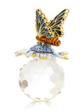 Decorative butterfly figurine with a gold body and blue wings on a white background
