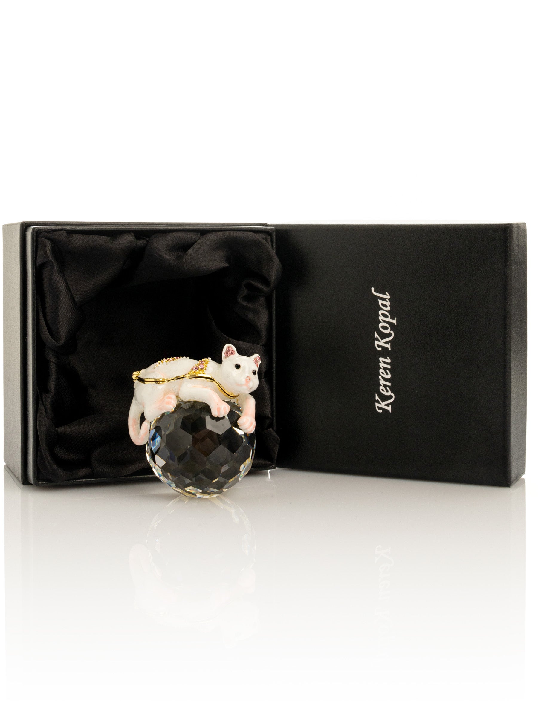 White cat figurine on crystal ball in Keren Kopal branded black box