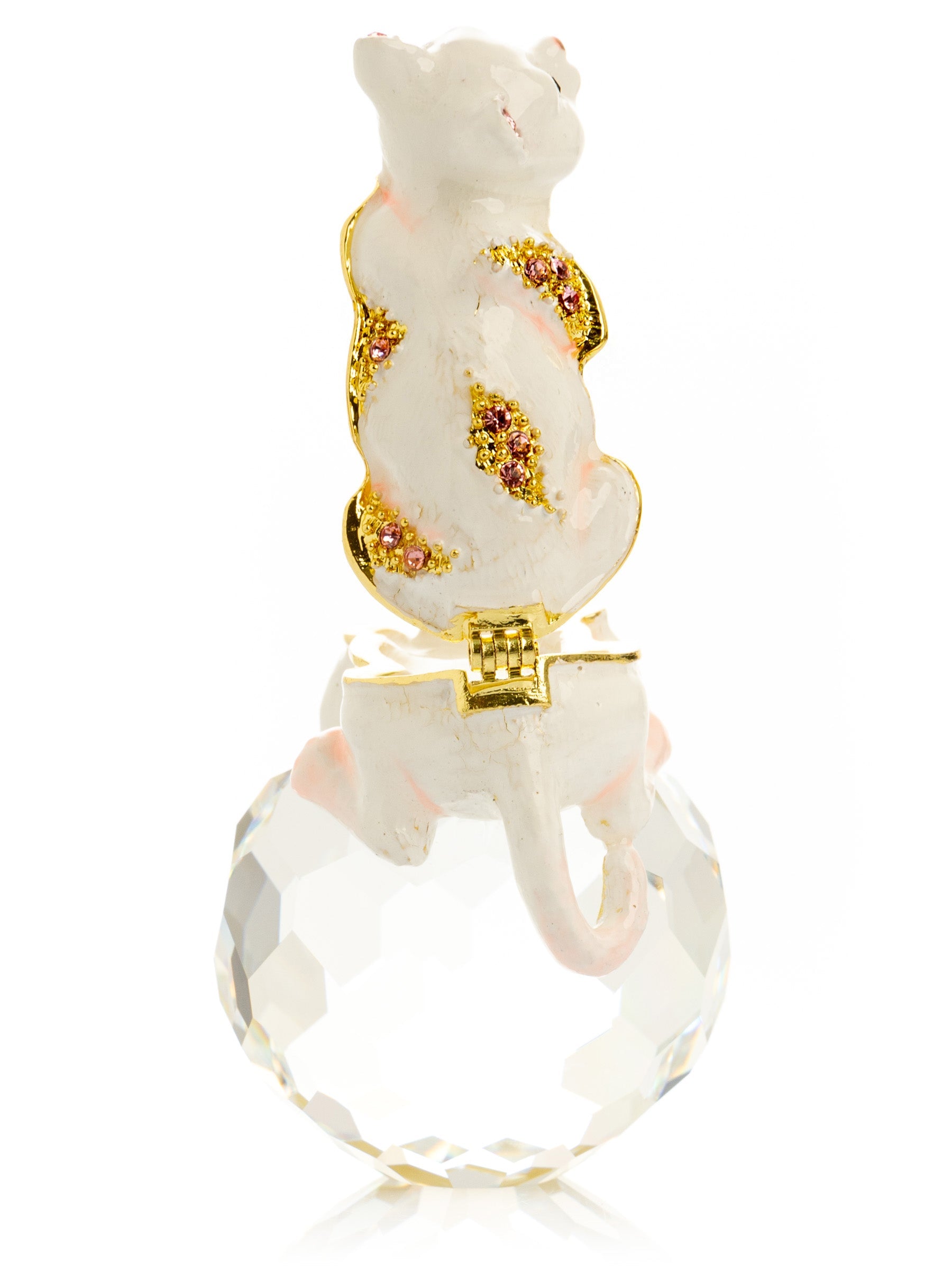 Decorative cat figurine with gold and gemstone accents on a clear crystal base.