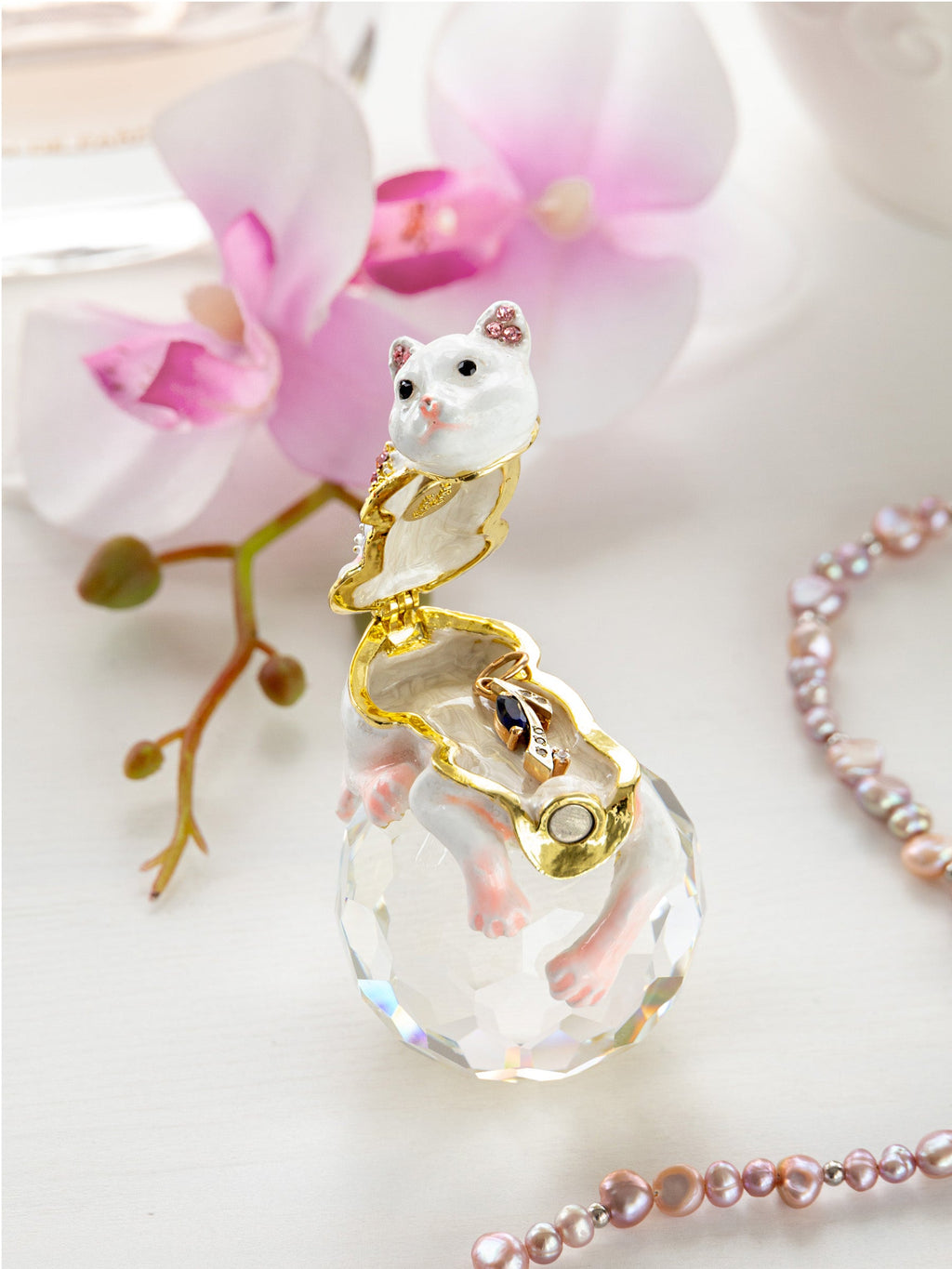 Crystal pendant with cat design on a white background