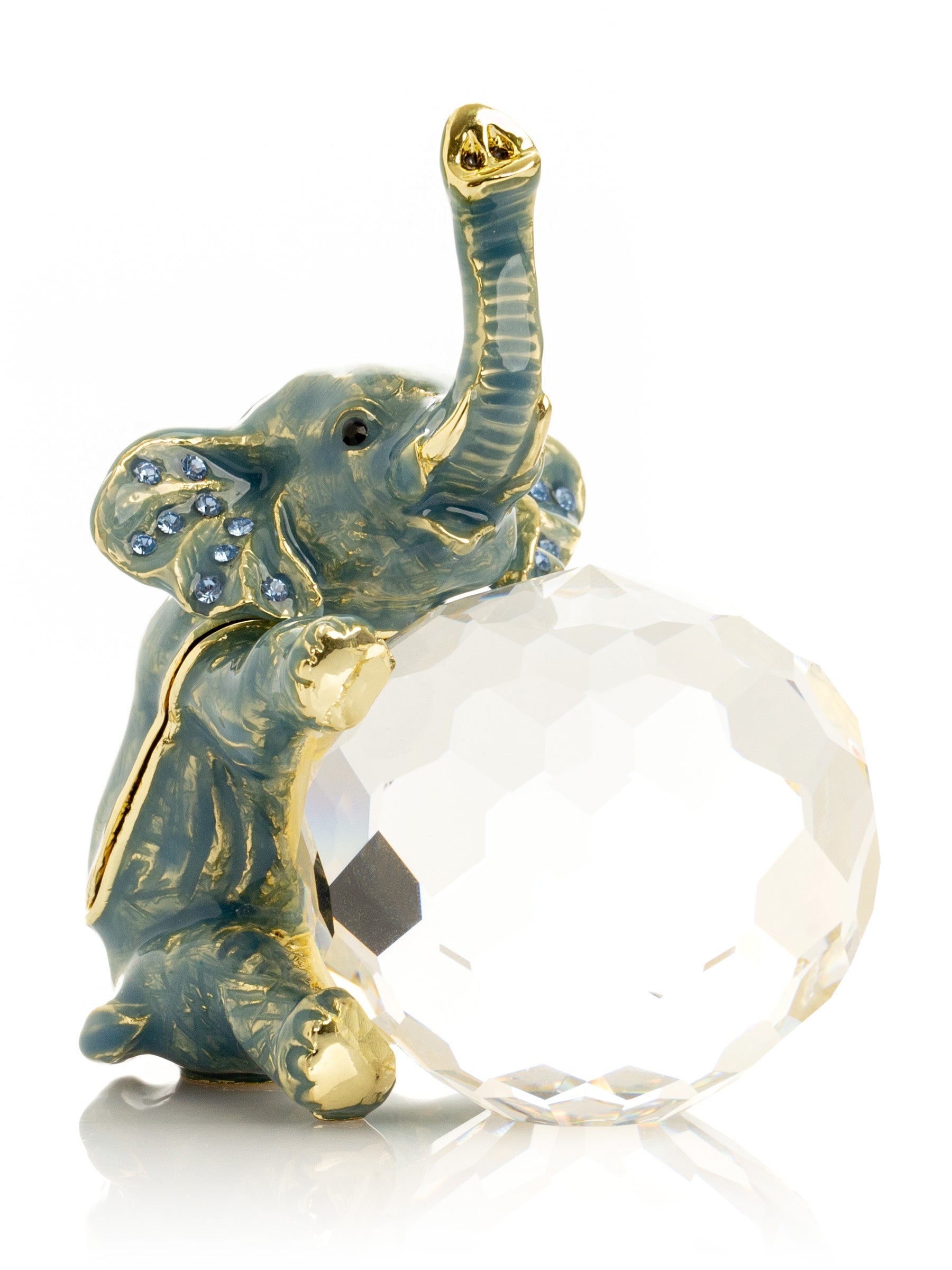 Decorative elephant figurine with a crystal ball on a white background