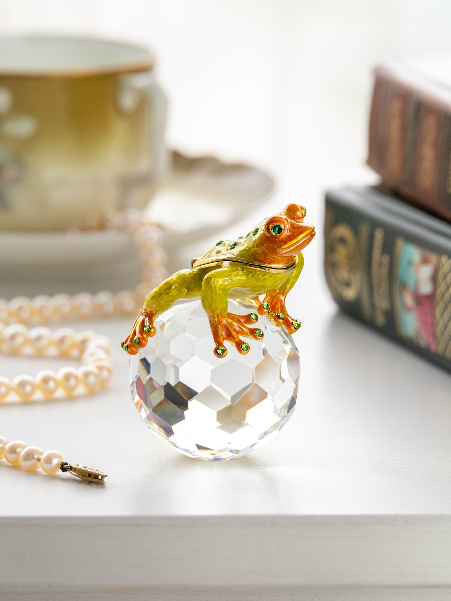 Frogs on a crystal ball with a blurred background
