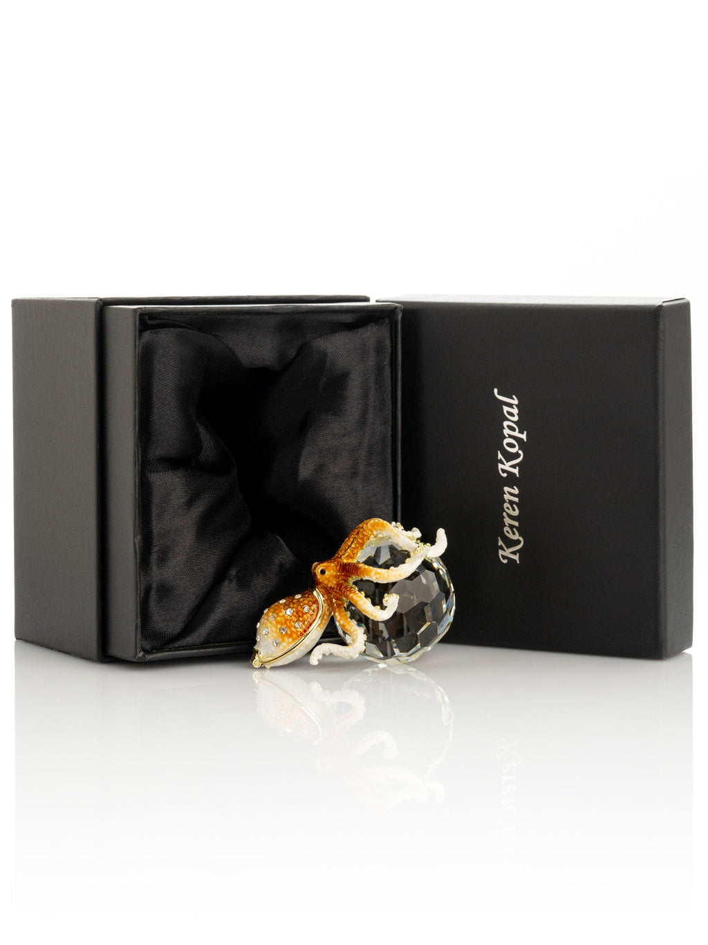 Glass octopus figurine in a black Keren Kopal box on a white background
