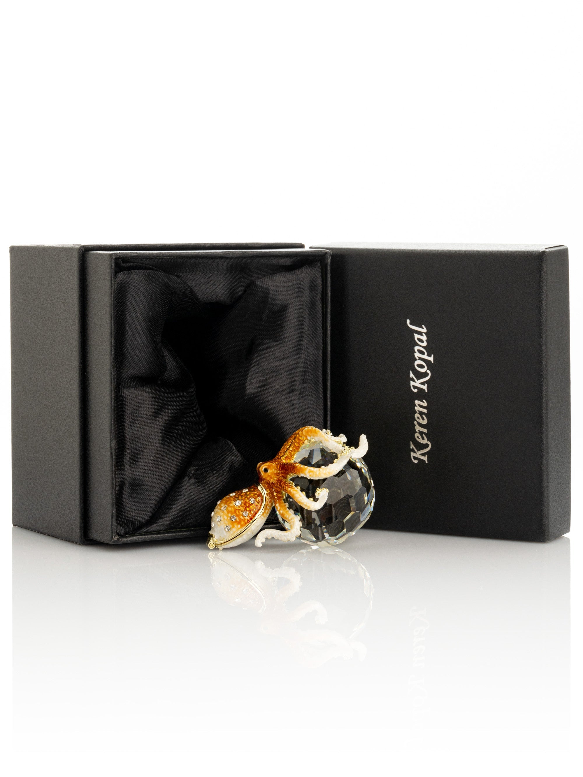 Glass octopus figurine in a black Keren Kopal box on a white background