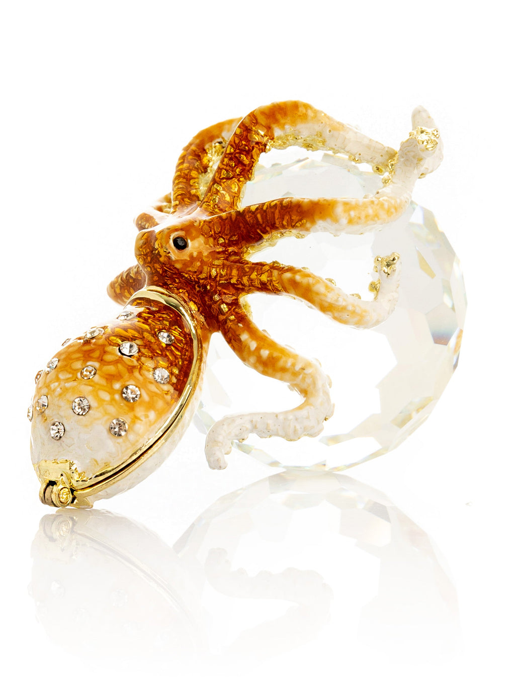 Gold and white octopus-shaped jewelry piece on a white background