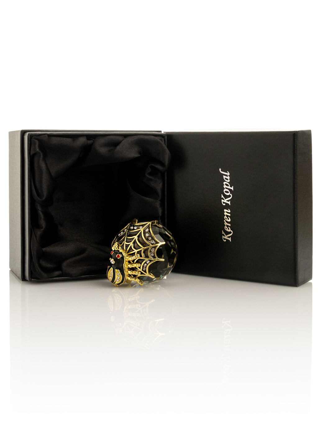 Decorative ornament with spider design in a Keren Kopal box on a white background
