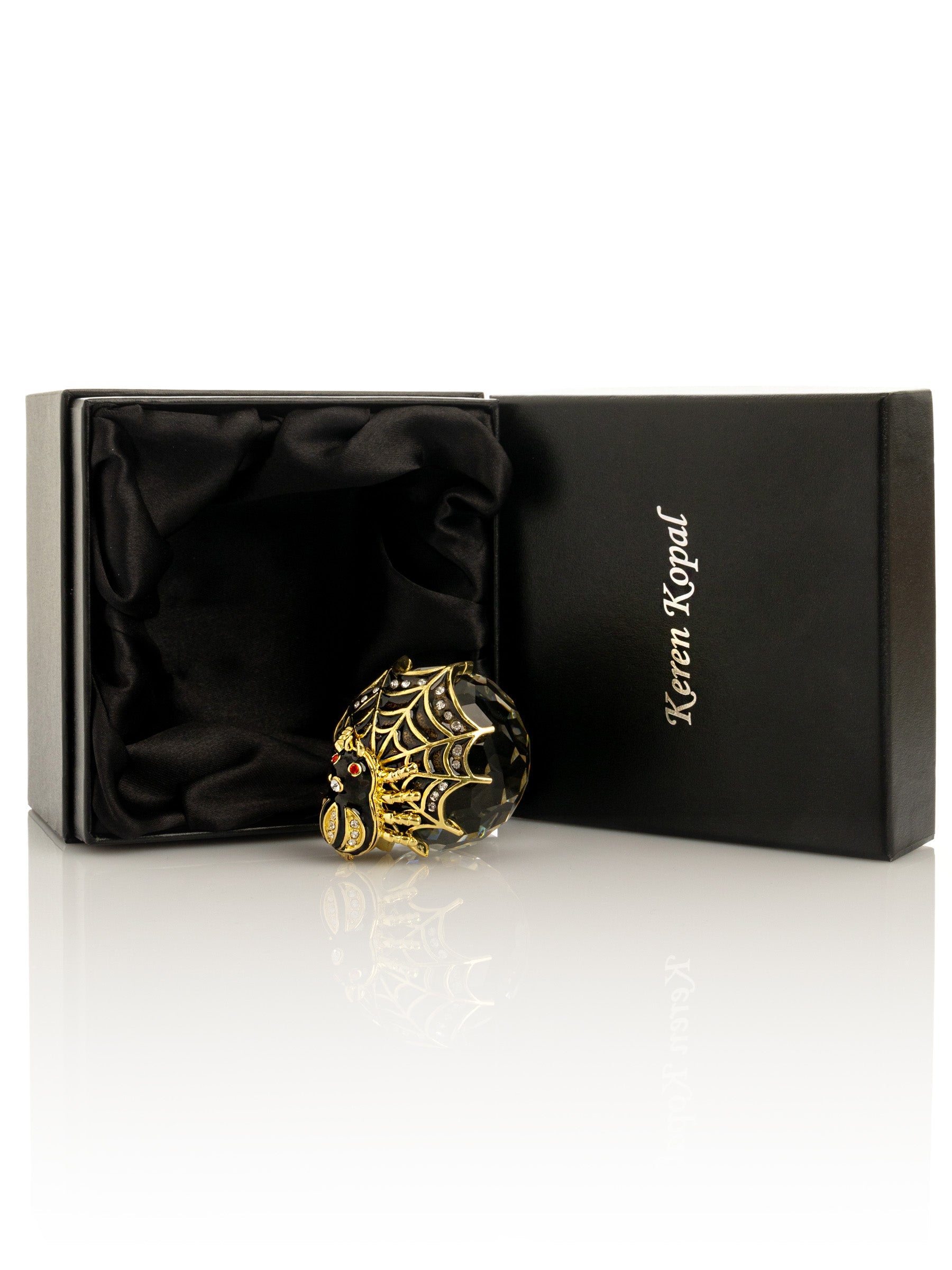 Decorative ornament with spider design in a Keren Kopal box on a white background