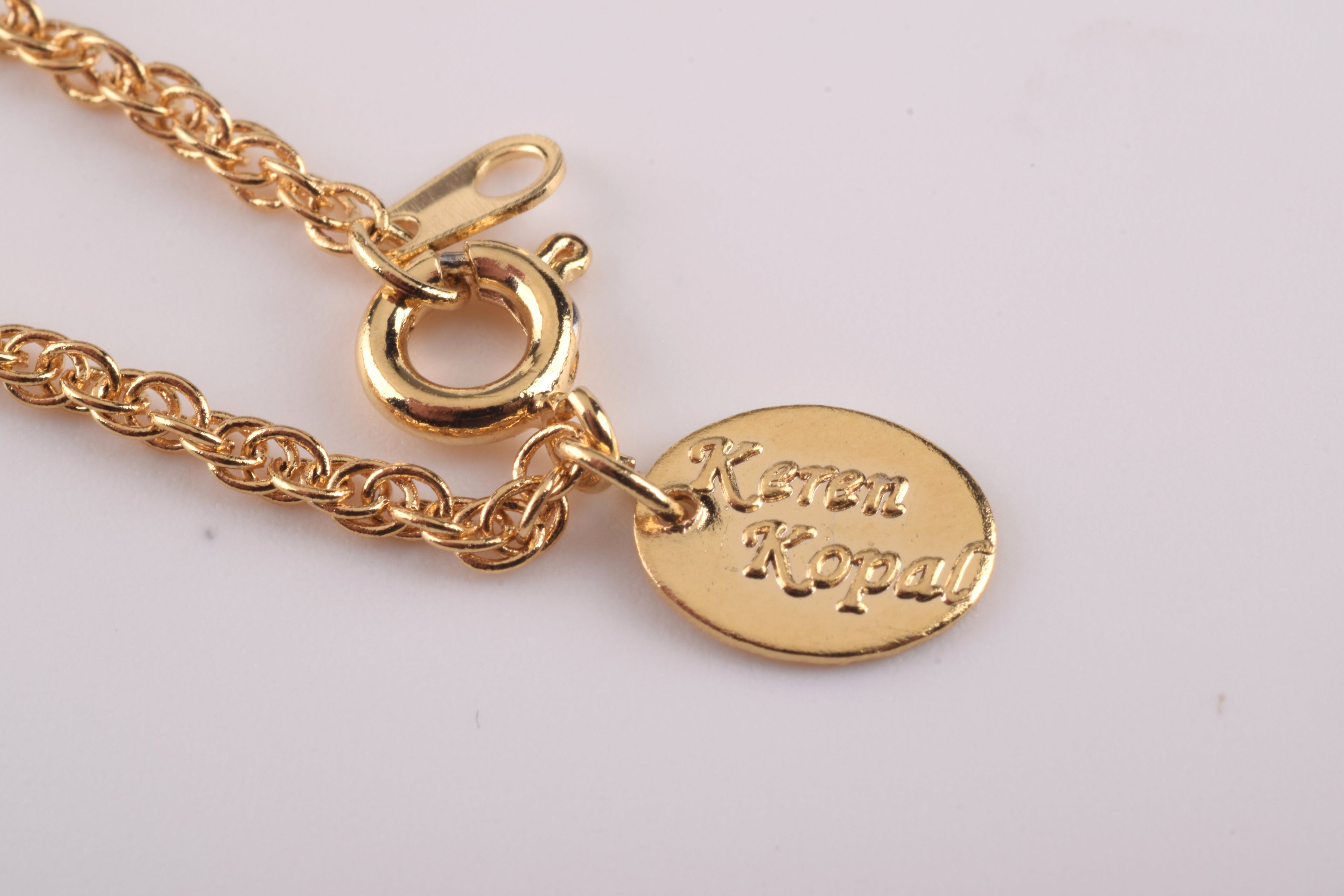 Designer Keren Kopal gold chain clasp close-up - White heart pendant necklace detail - 24K gold plated luxury jewelry with spring ring closure