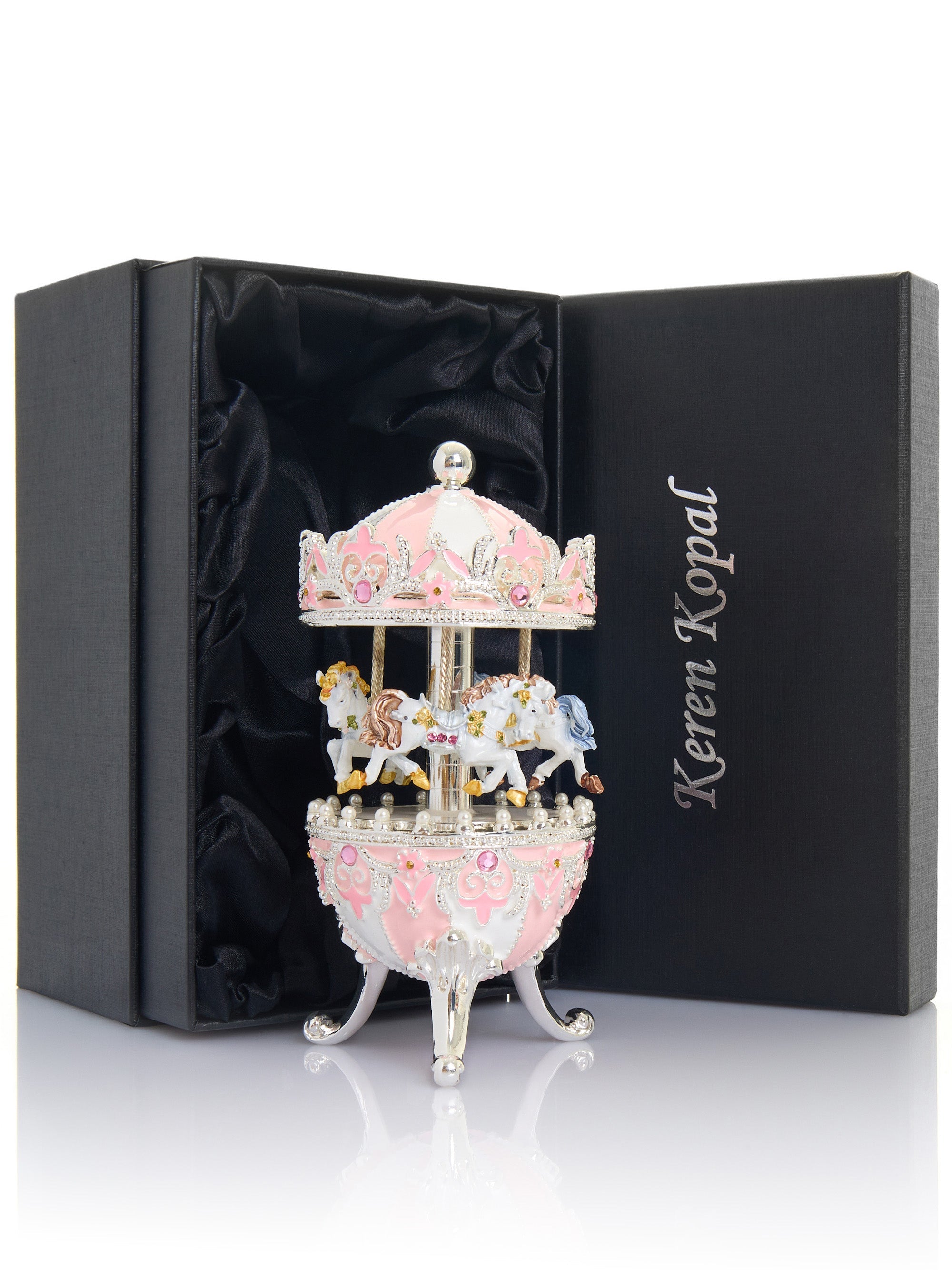 Decorative carousel figurine in a black box with 'Keren Kopal' branding.