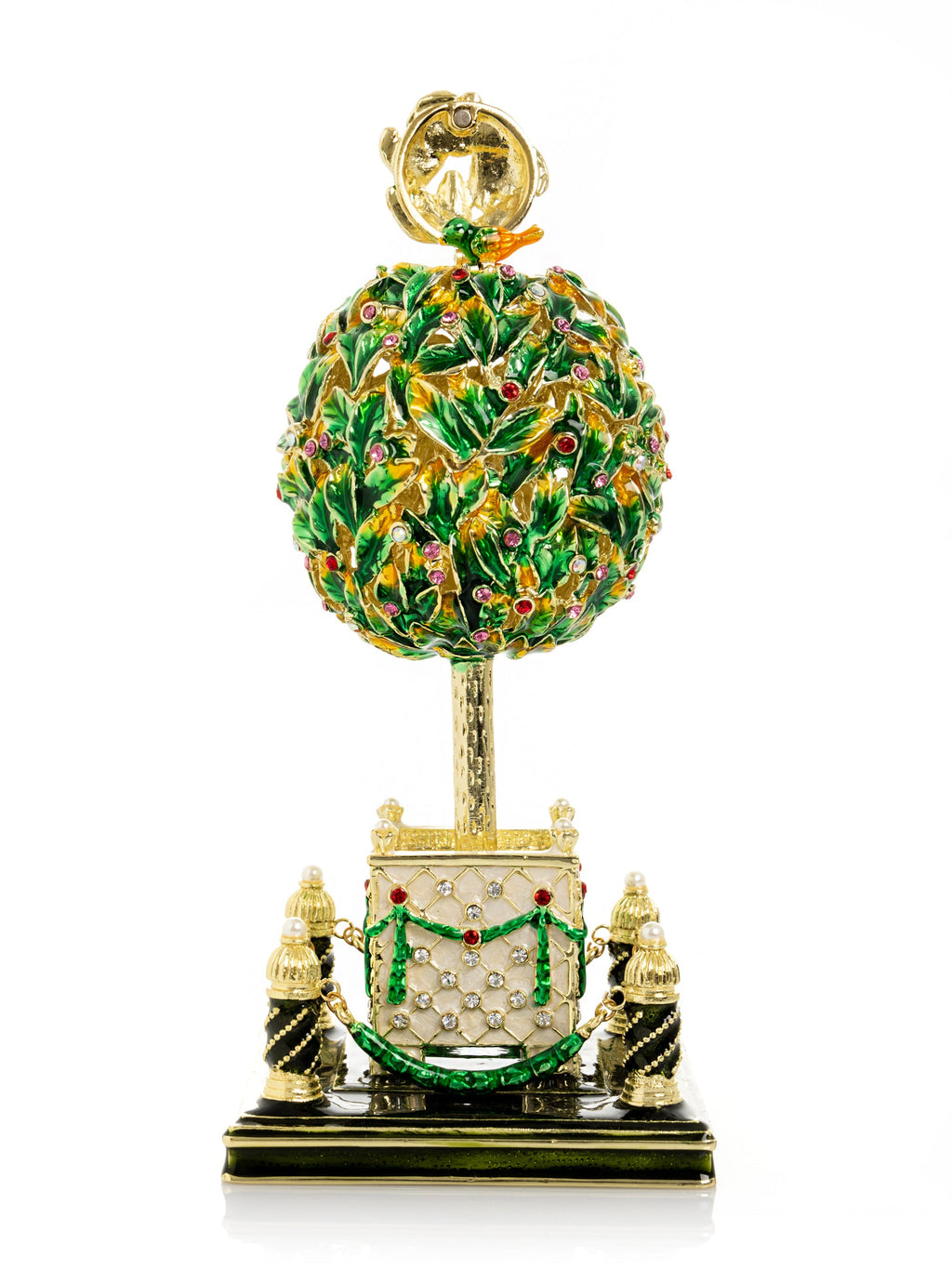 Decorative topiary sculpture with gold and green details on a white background