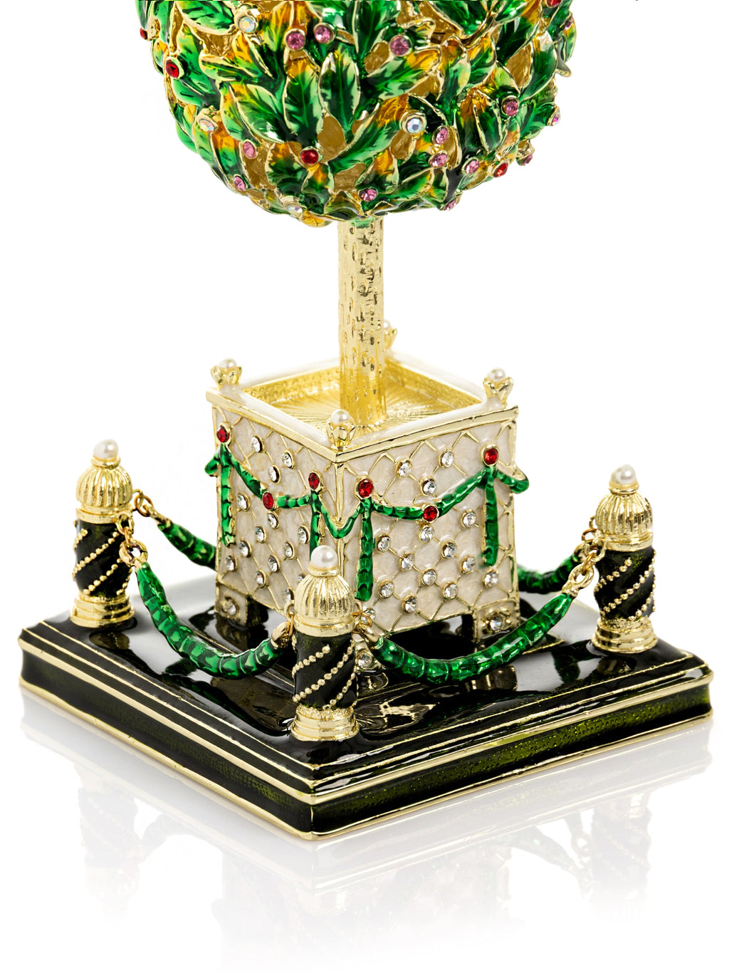 Decorative topiary sculpture with green leaves, gold accents, and a square base on a white background