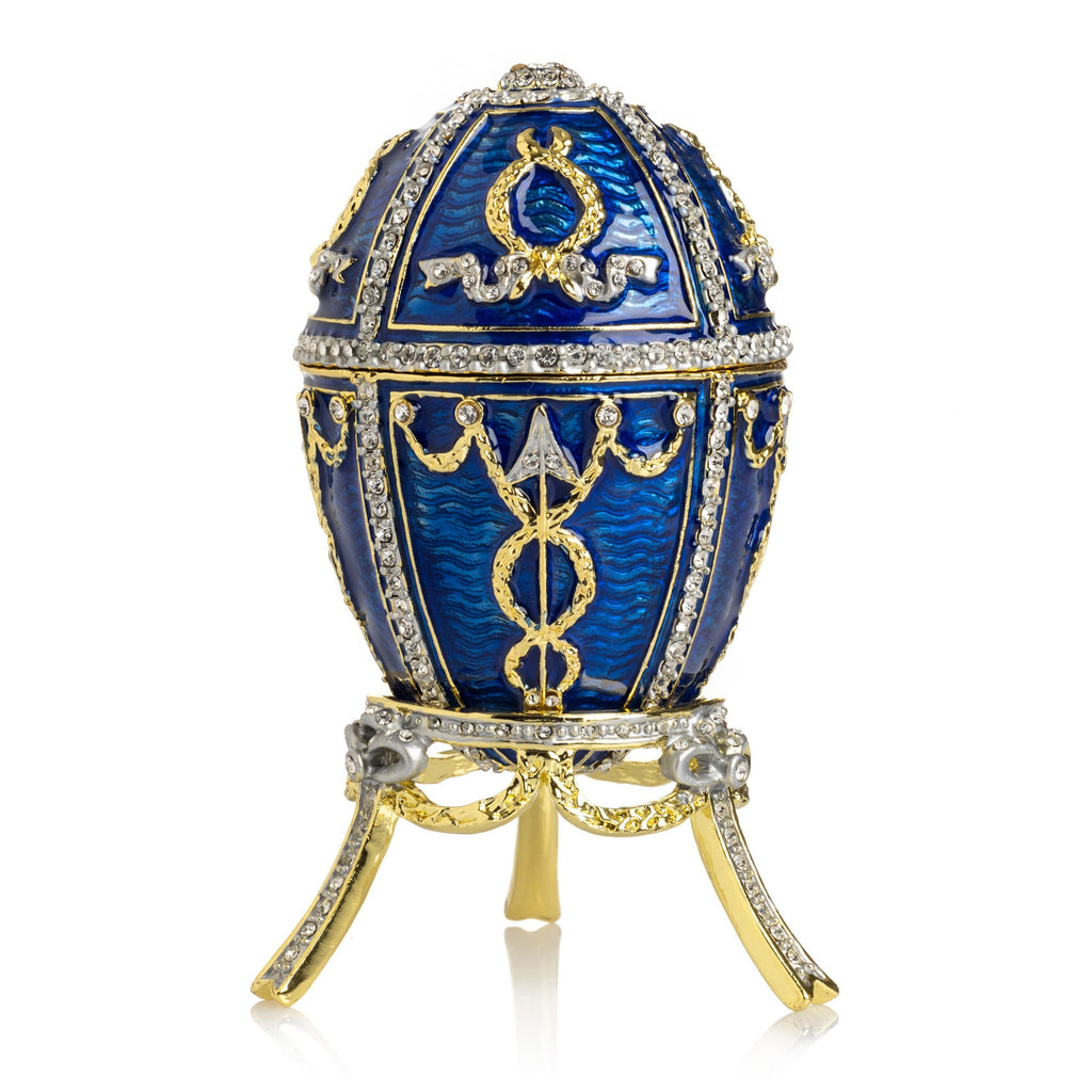 Decorative blue egg with gold and silver embellishments on a white background