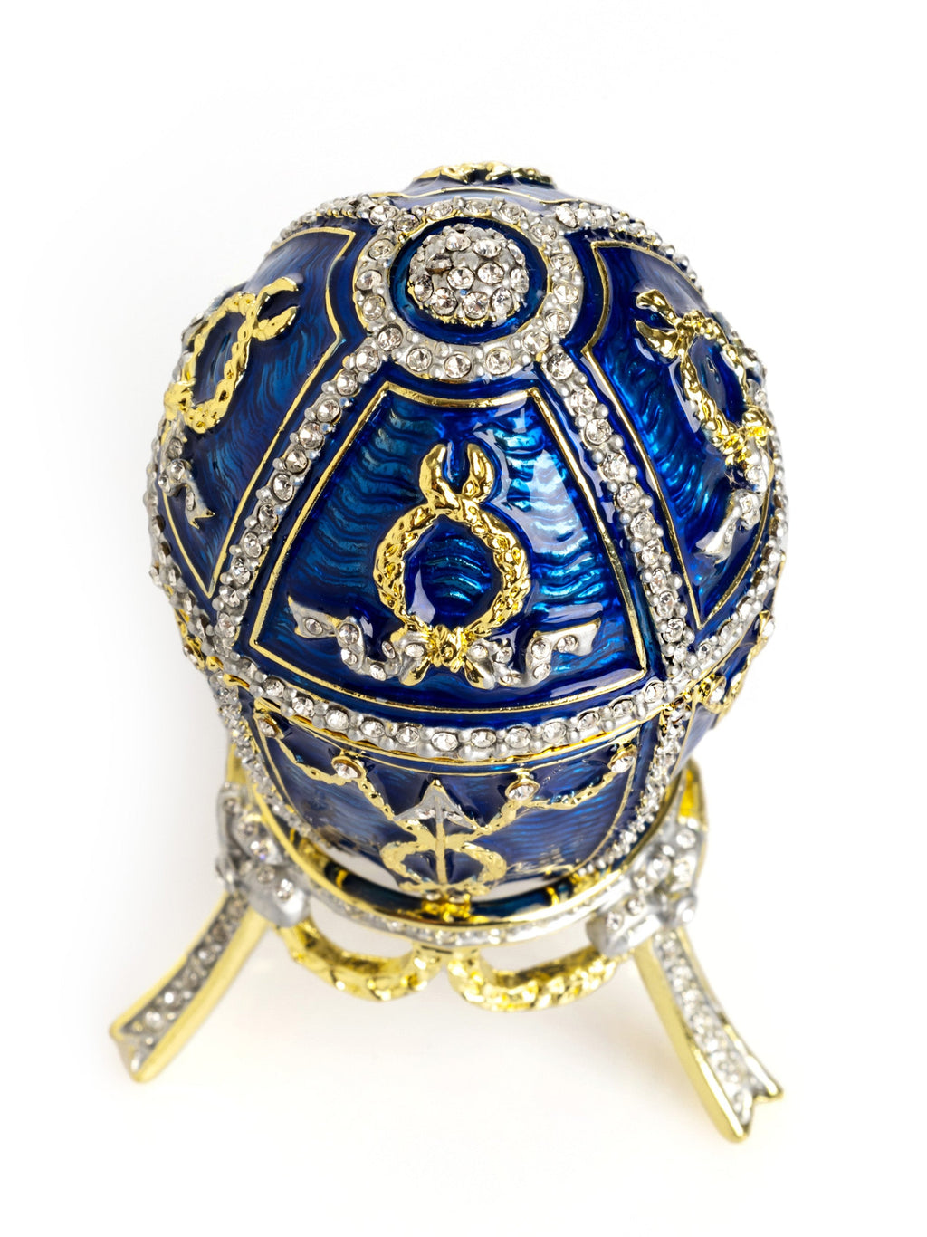 Decorative blue egg with gold and crystal embellishments on a white background