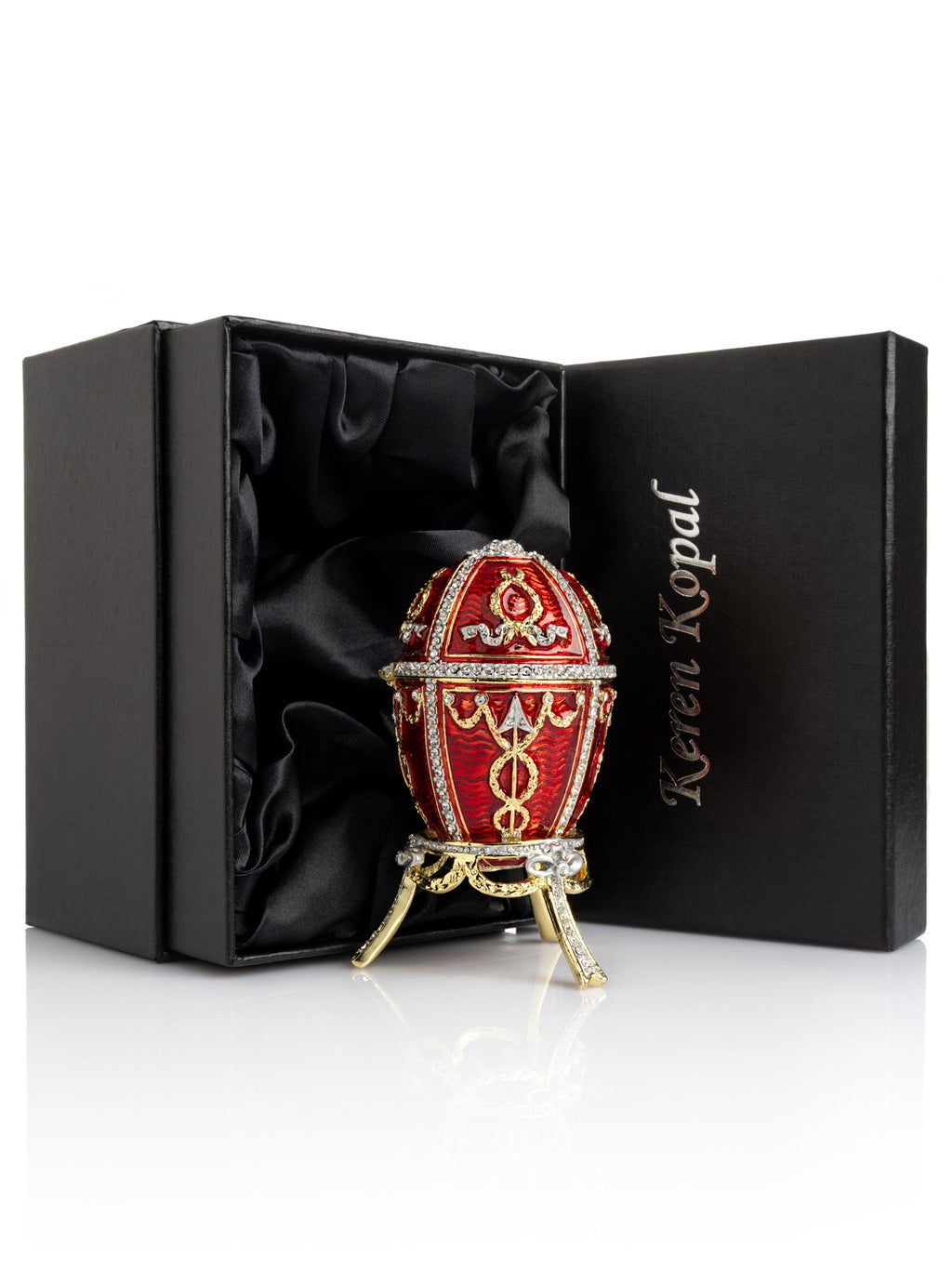 Decorative red and gold egg in a black satin-lined box with Keren Kopal branding.