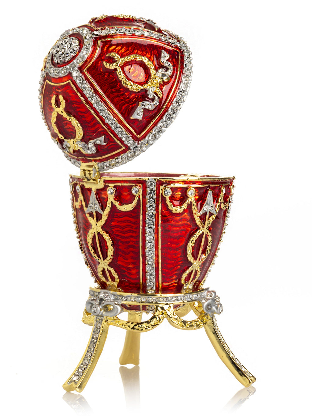 Decorative red egg with gold and silver embellishments on a white background