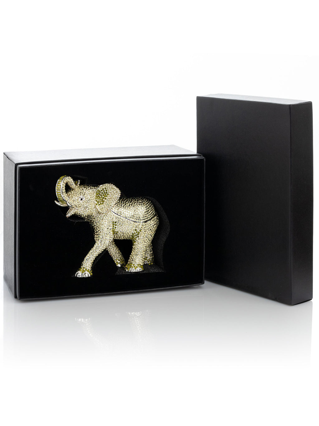 Gold elephant figurine in a black box on a white background