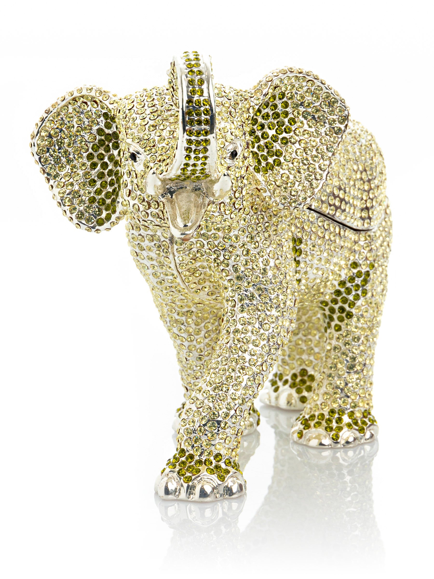 Decorative elephant figurine with gemstone embellishments on a white background