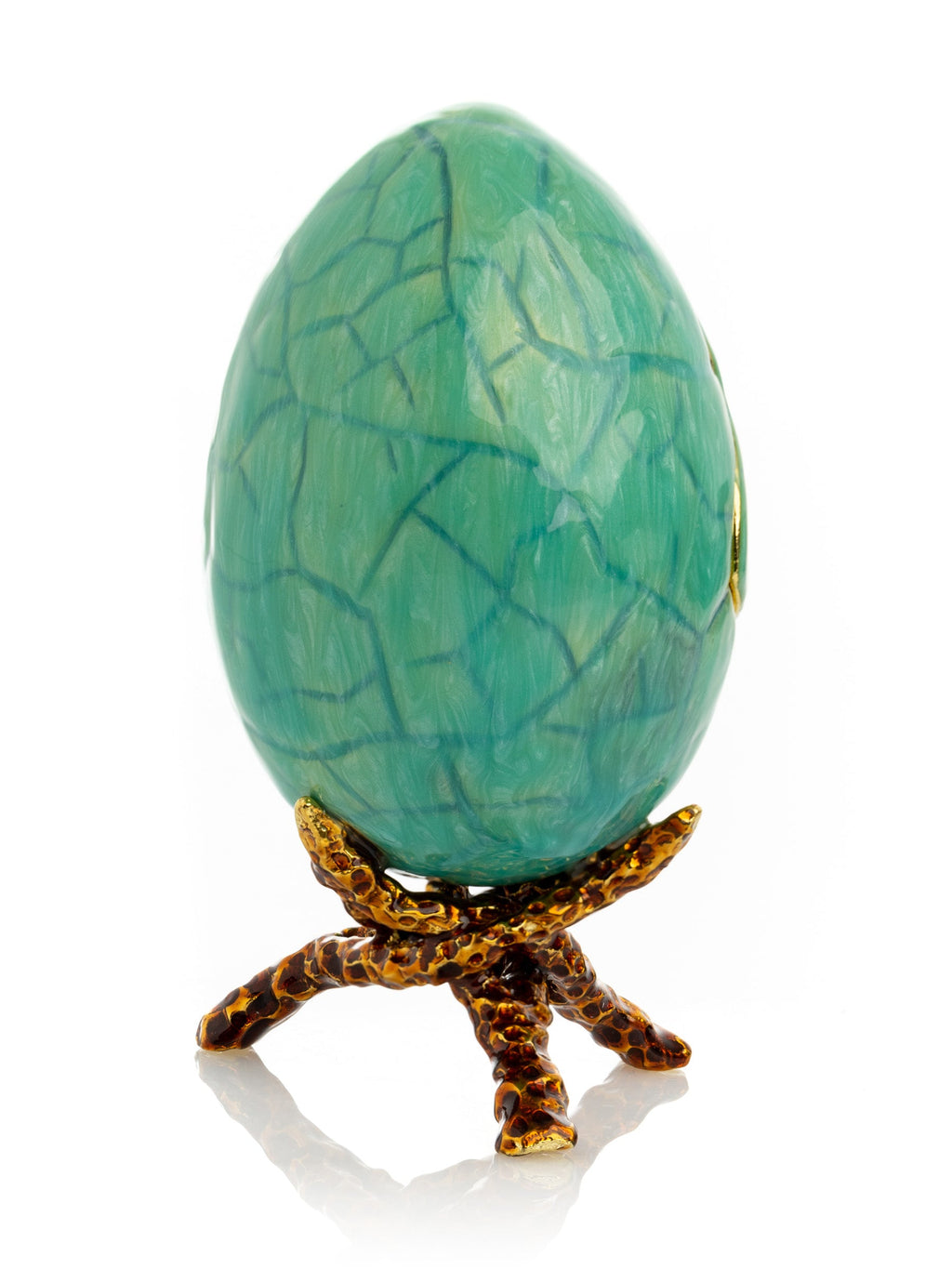 Turquoise egg-shaped object on a decorative stand with a white background