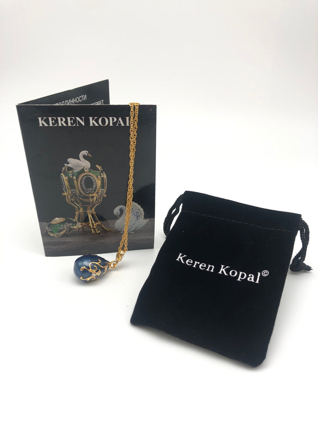 Jewelry set with necklace, pendant, and Keren Kopal packaging on a white background