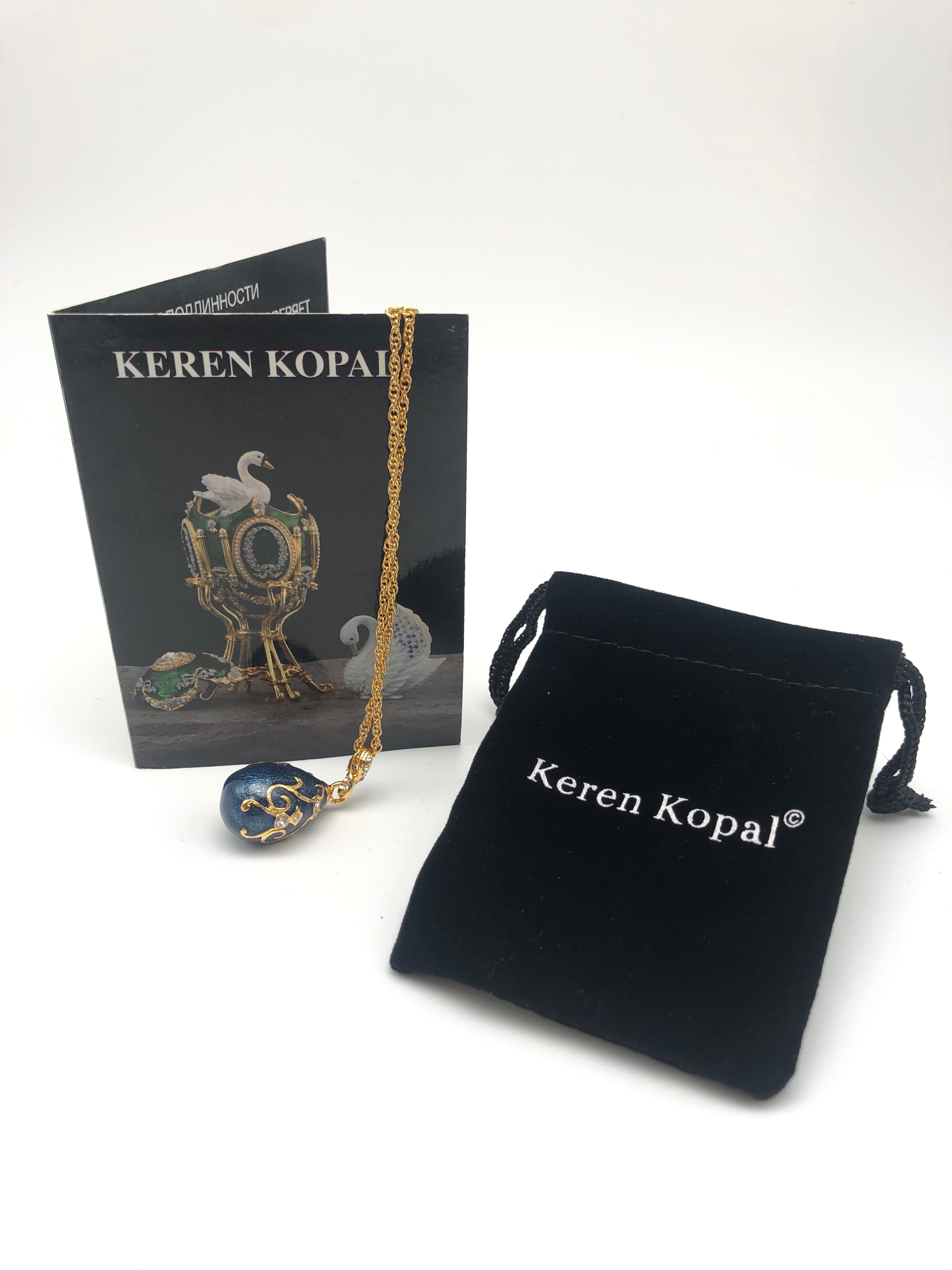 Jewelry set with necklace, pendant, and Keren Kopal packaging on a white background