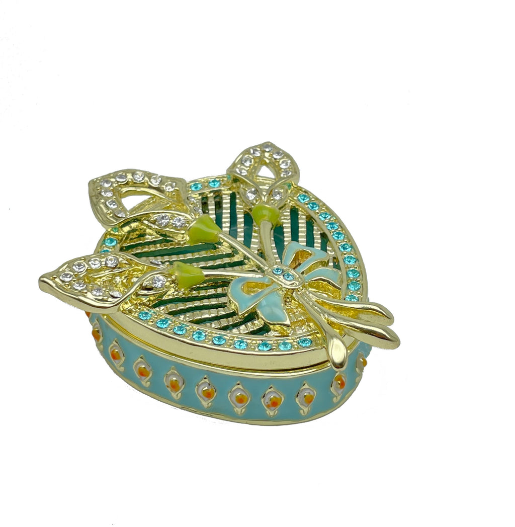 Decorative jewelry box with gold, green, and blue colors on a white background